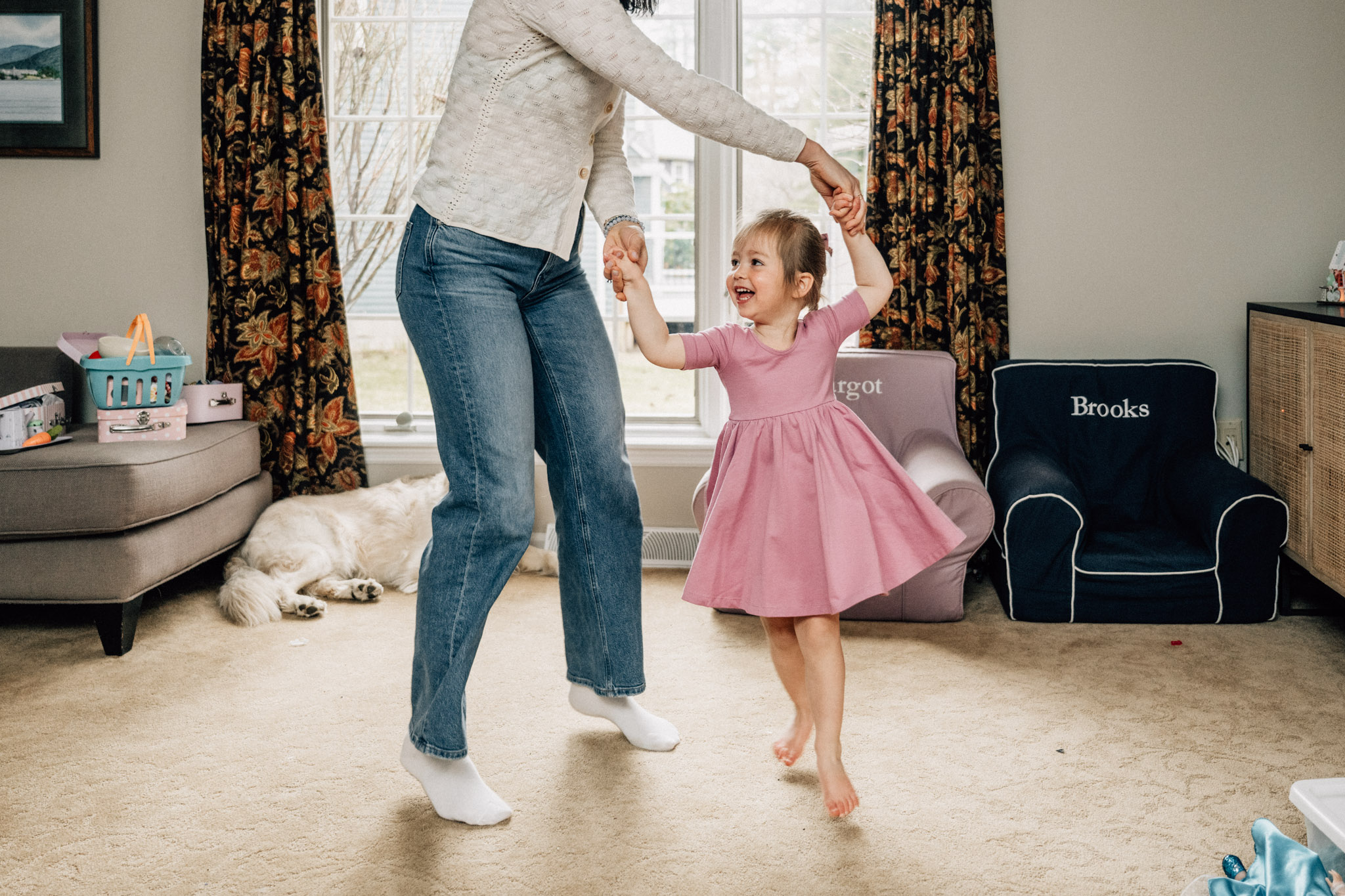 Little girl dances with her mother in the living room. She is having so much fun!