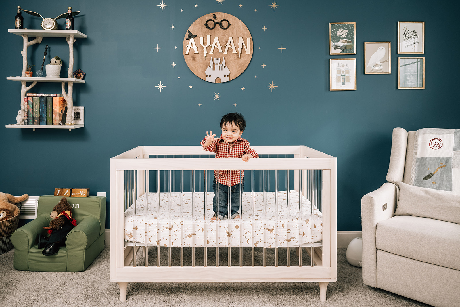 Baby standing in crib during milestone session, celebrating growth in the first year of newborn photos.