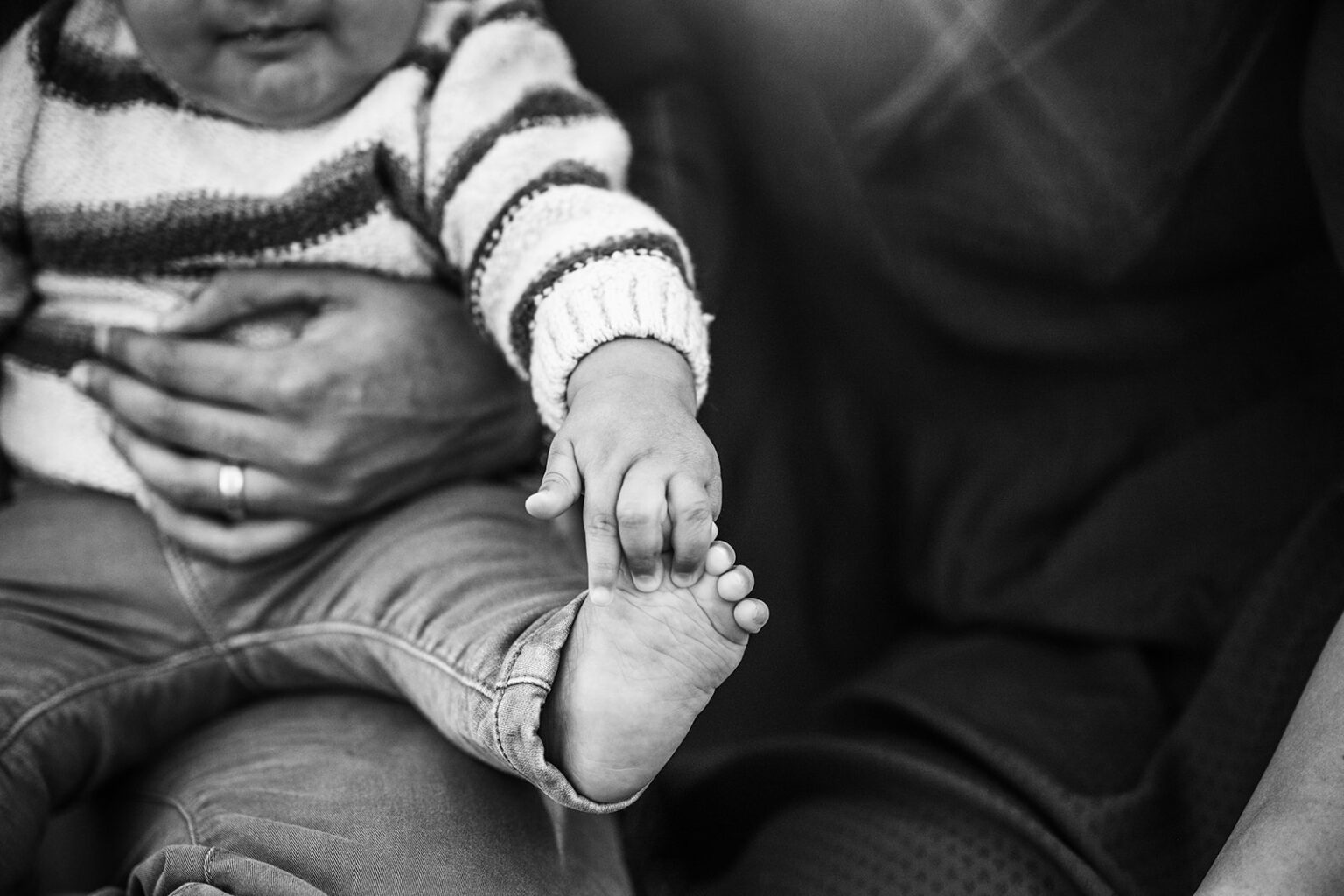 Black and white detail of baby’s feet, documenting quiet moments from the first year of newborn photos.