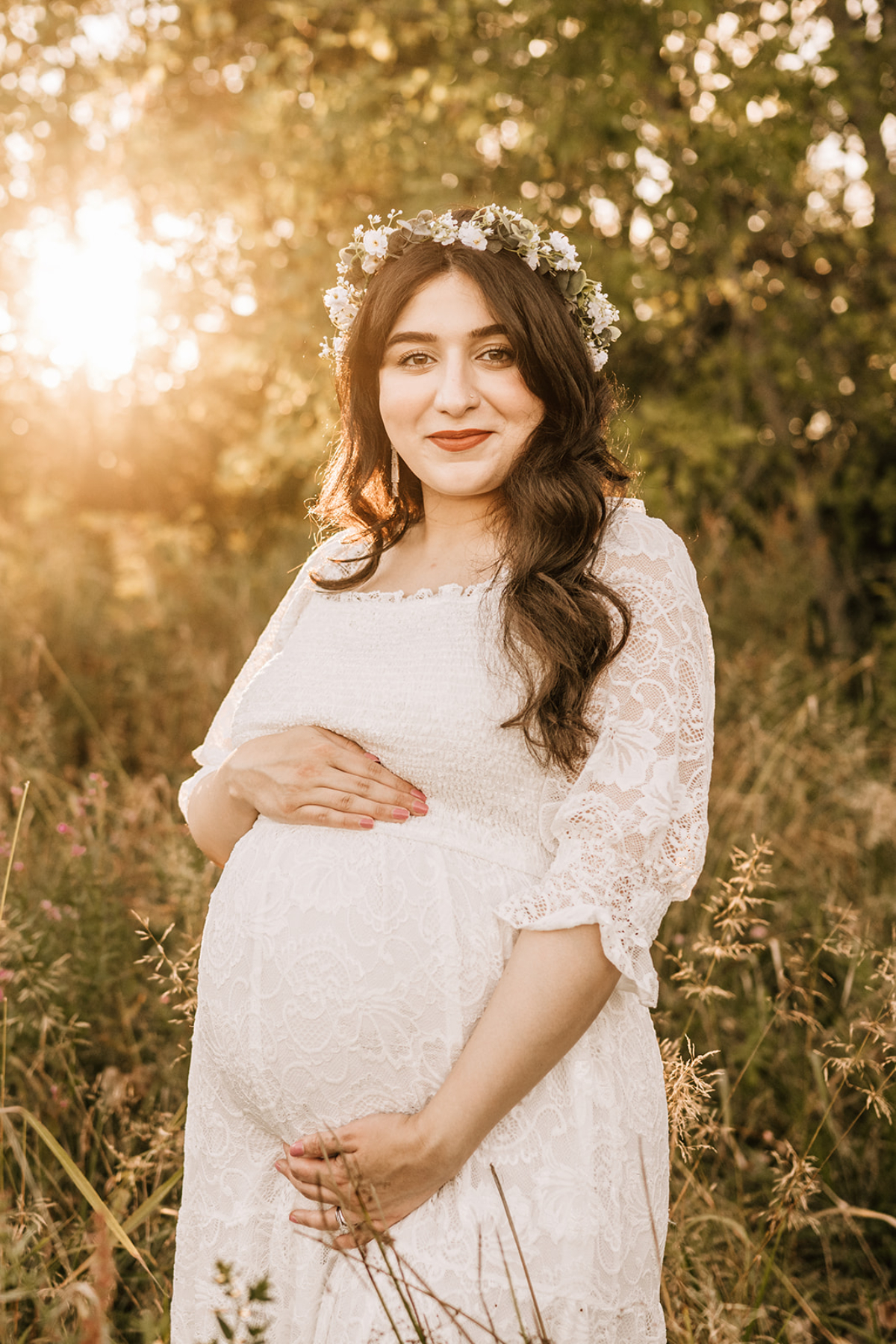 Pregnant woman wearing a floral crown outdoors during milestone photography maternity session, documenting calm and growing anticipation.