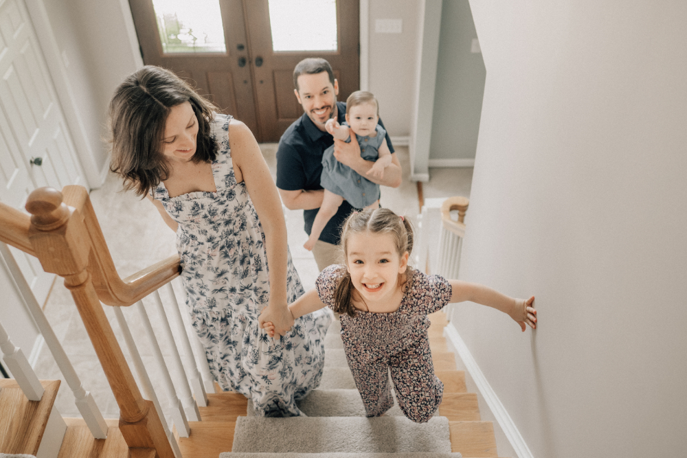 A family shares a playful everyday moment together at home, filled with movement, laughter, and connection.